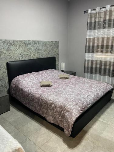 a bedroom with a bed with two shoes on it at Casa Venera in Turin