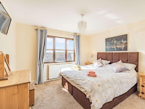 a bedroom with a large bed and a window at 3 Bed in Berwick-upon-tweed oc-87777 in Lamberton