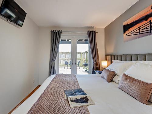 a bedroom with a bed with a book on it at 2 Bed in Castle Douglas oc-59637 in Castle Douglas