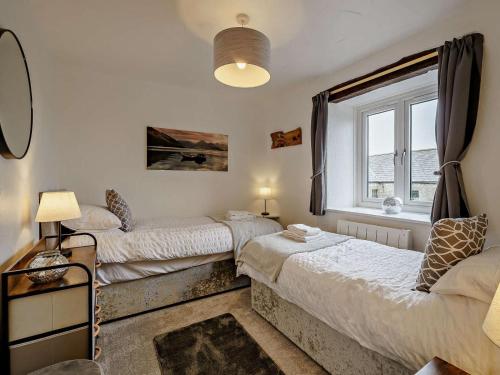 a bedroom with two beds and a window at 2 Bed in Carnforth oc-90530 in Beetham