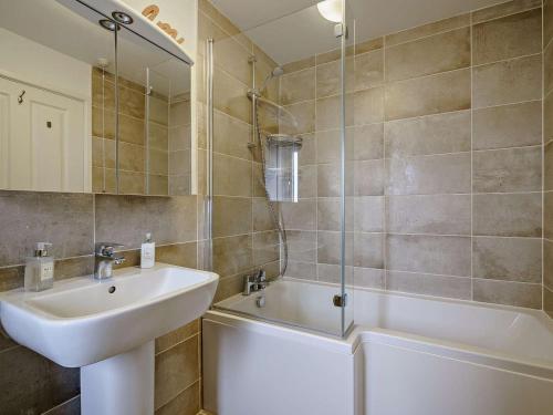a bathroom with a sink and a bath tub at 2 Bed in Carnforth oc-90530 in Beetham