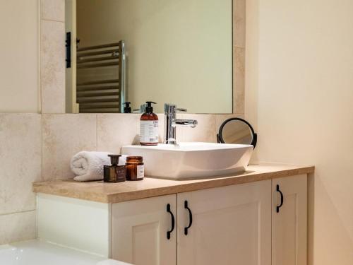 a bathroom with a sink and a mirror at 3 Bed in Bath oc-skn21 in Wellow
