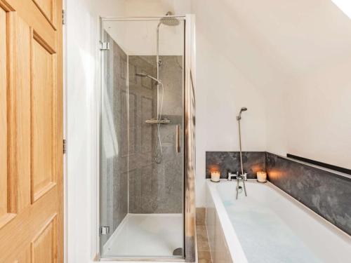 a bathroom with a shower and a white tub at 3 Bed in Pershore oc-86760 in Eckington