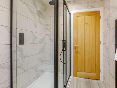 a bathroom with a shower with a glass door at 4 Bed in Holsworthy oc-85673 in Bridgerule