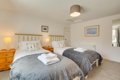 a bedroom with two beds with towels on them at 3 Bed in Brancaster oc-2153 in Brancaster