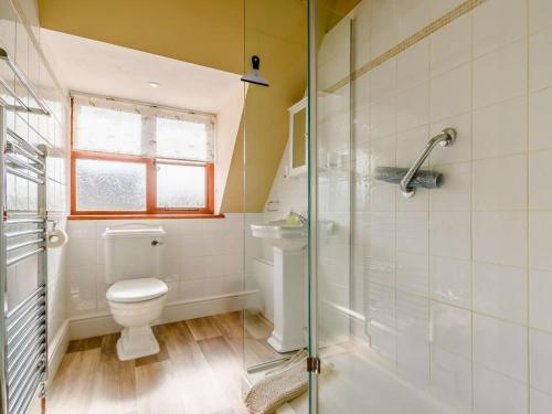 a bathroom with a toilet and a glass shower at 3 Bed in Evesham oc-89477 in Bretforton