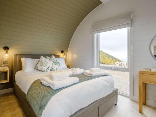 a bedroom with a large bed with towels on it at 2 Bed in Tain oc-81340 in Nigg