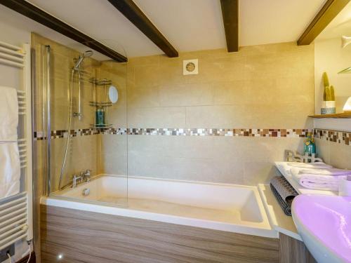 a bathroom with a tub and a sink at 1 Bed in Carnforth oc-90528 in Beetham