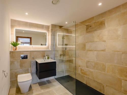 a bathroom with a toilet and a sink and a shower at 5 Bed in Lancaster oc-90546 in Burton in Lonsdale