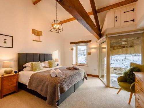 a bedroom with a bed with two towels on it at 5 Bed in Lancaster oc-90546 in Burton in Lonsdale