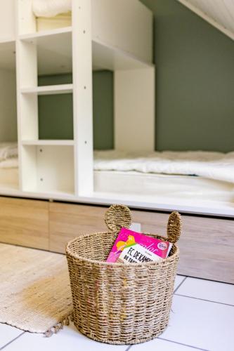 a basket sitting on the floor in a bedroom with bunk beds at Le Louis Vakantiehuis in Lanaken