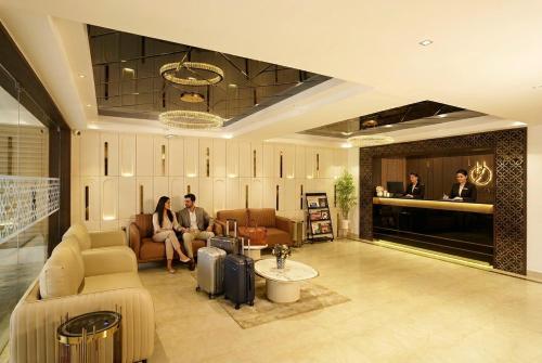 a group of people sitting in a lobby at Liza Royale Hotel Near Chennai central Railway Station in Chennai