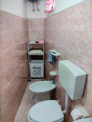 a bathroom with a white toilet and a sink at Antica dimora LUNA in Casarano