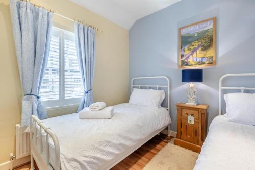 two twin beds in a room with a window at 2 Bed in Bakewell oc-t34225 in Bakewell
