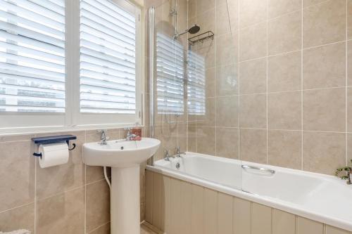 a bathroom with a sink and a bath tub at 2 Bed in Bakewell oc-t34225 in Bakewell