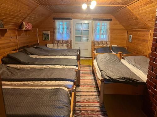 a room with four beds in a cabin at ADAM-OASIS in Borzont