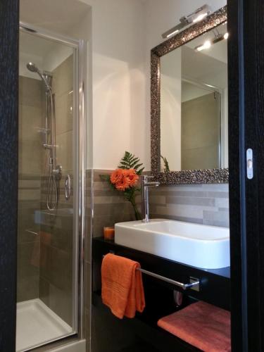 a bathroom with a sink and a shower and a mirror at Gemini Suite in Rome