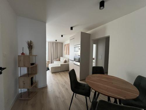 a living room with a table and chairs and a couch at Apartmán LÝRA Trenčín in Trenčín