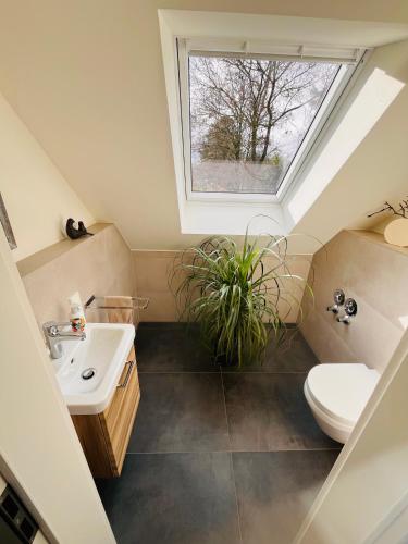 a bathroom with a sink and a skylight at Ferienwohnung Kastanieneck in Kevelaer