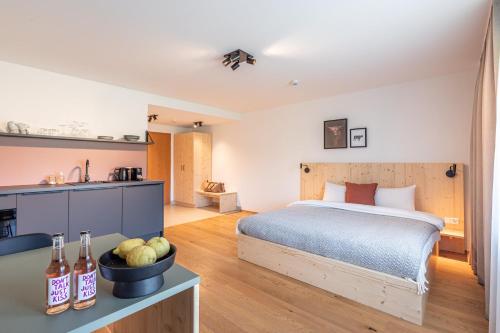 a bedroom with a bed and a counter with a bowl of fruit at stuub jostal in Titisee-Neustadt