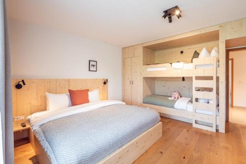 a bedroom with a bunk bed and a ladder at stuub jostal in Titisee-Neustadt