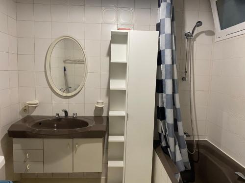 a bathroom with a sink and a mirror at Studio vintage in Parthenay