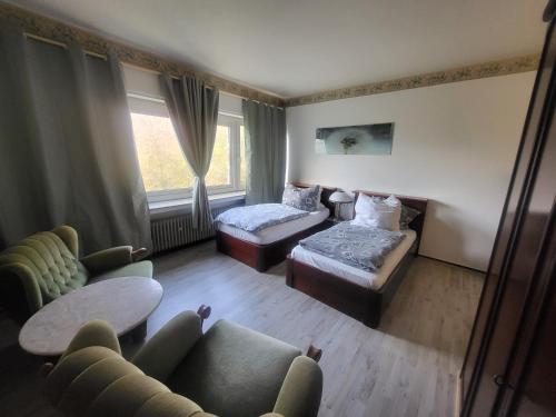 a living room with a couch and a bed at Hotel Schlaun in Nordkirchen