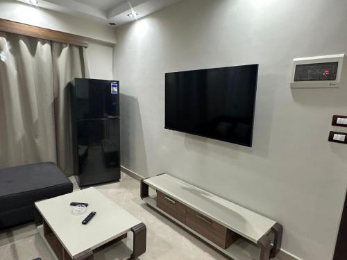 a living room with a flat screen tv on a wall at Sharm Glow Villa in Sharm El Sheikh