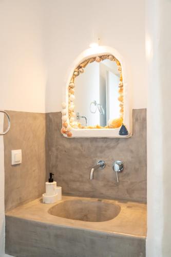 a bathroom with a sink and a mirror at Little Garden in Pera Gyalos