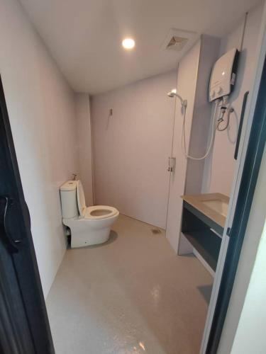 a small bathroom with a toilet and a sink at Hi-Inn in Miri