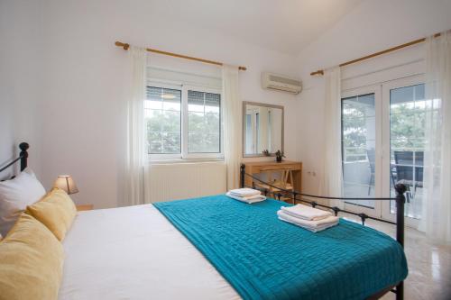 a bedroom with a bed with two towels on it at Apartment Margerita in Asgourou