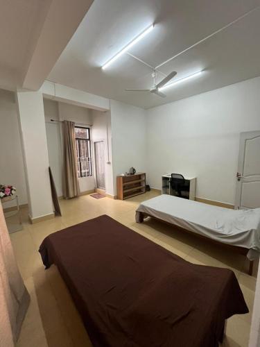 a bedroom with a large bed in a room at W-26 Dawrpui in Āīzawl
