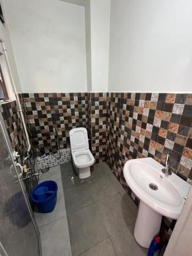 a bathroom with a toilet and a sink at W-26 Dawrpui in Āīzawl