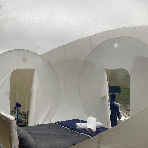 a person is standing in a white tent at Wooded Bubble in Kent