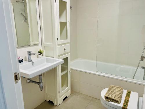 a bathroom with a sink and a toilet and a shower at Ático frontal al mar en Duna Beach con vistas in Torrox Costa