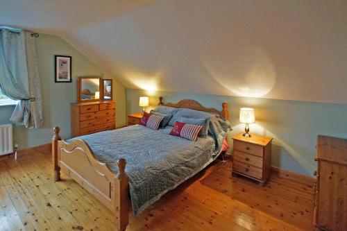 a bedroom with a bed and a dresser and a mirror at 6 Bed in Clonbur oc-i275 in Finny