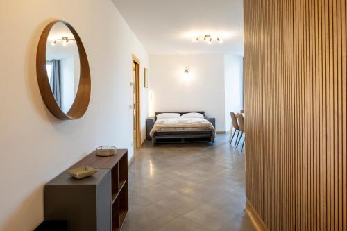 a bedroom with a bed and a mirror on the wall at - Magenta Apartment - in Monfalcone