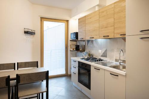 a kitchen with a sink and a stove at - Magenta Apartment - in Monfalcone