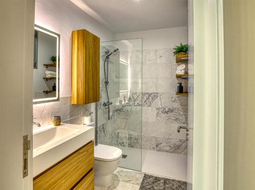 a bathroom with a shower and a toilet and a sink at MSV Beach in Puerto Naos
