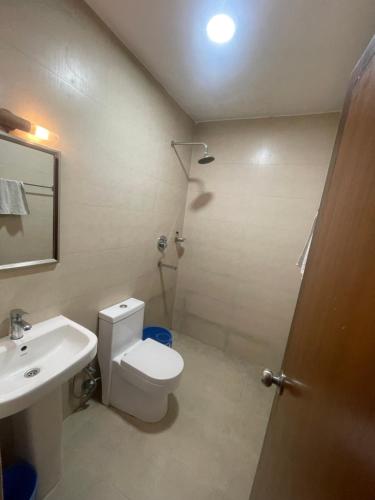 a bathroom with a toilet and a sink and a shower at Pacific Guest House in Kathmandu