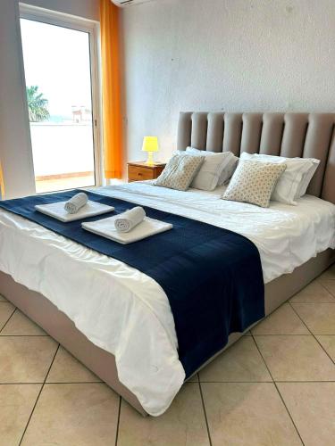 a large bed with two towels on top of it at Vila Praia Apartment in Albufeira