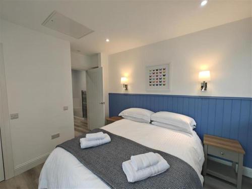 a bedroom with a bed with two towels on it at 1 Bed in Isle Of Arran oc-96463 in Dougarie