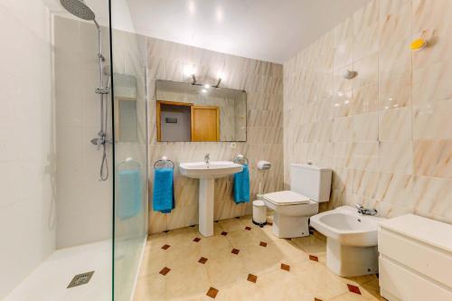 a bathroom with a sink and a toilet and a shower at Emma Beachfront Apartment by Sealand Villas in Port de Pollensa