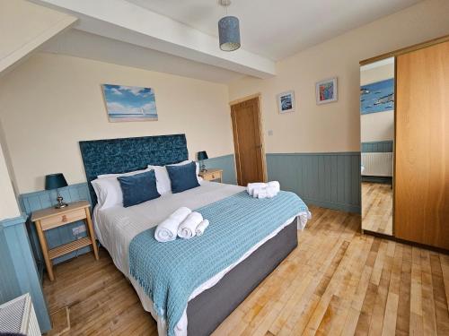 a bedroom with a bed with towels on it at Argyle Lodge in Rush