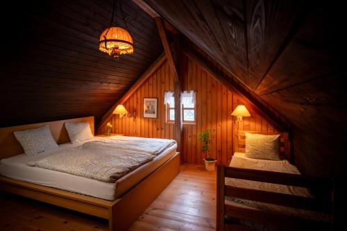 a bedroom with a bed and a chandelier at Pod jednou střechou in Libošovice