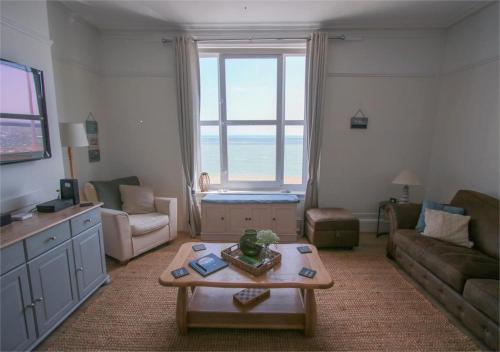 a living room with a couch and a coffee table at Beach View - A Truly Stunning House Opposite The Sea! Sleeps 10! Families, Friends, Contractors and Pets are all Welcome! in Sandgate