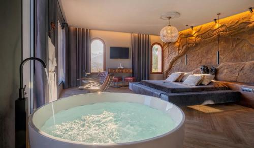 a room with a tub in the middle of a living room at Finca el Tossal - Adults Only in Bolulla