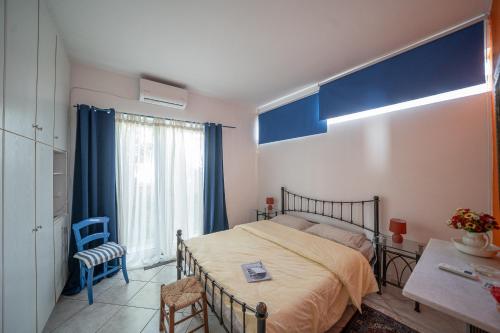 a bedroom with a bed and a table and a window at Seafarer's Suite by Filos Inc in Galaxidi