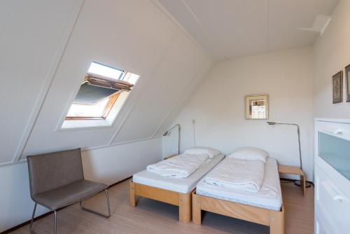 a hospital room with a bed and a chair at Vleijenhof Type C in Buren