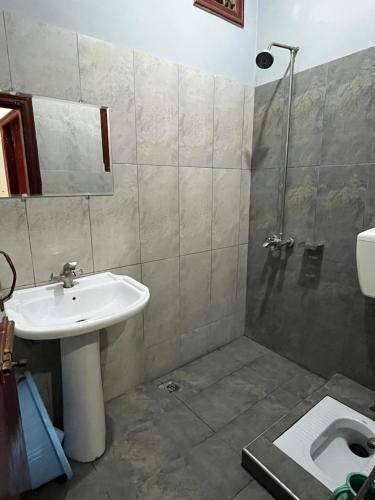 a bathroom with a sink and a shower at Qaiser Hotel in Lahore